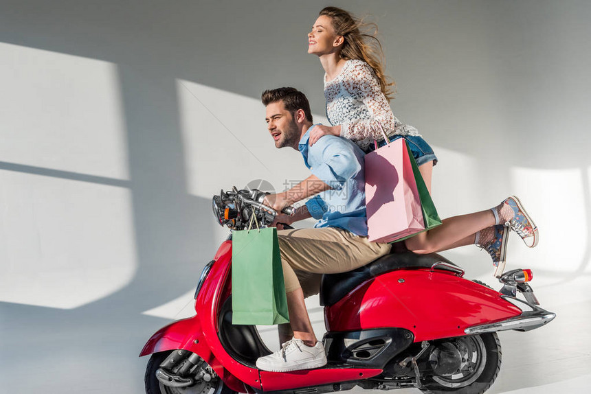 时尚夫妇坐上红色摩托车购物去图片