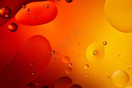 以橙色混合水和油的美丽抽象背景图片