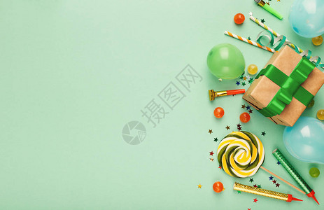 生日派对背景与纸屑糖果棒糖和礼物在绿色背景复制空间顶视图的边界祝贺图片