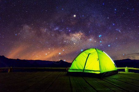 在夜空中满是星和银河的竹梯田下的绿化露营帐篷图片
