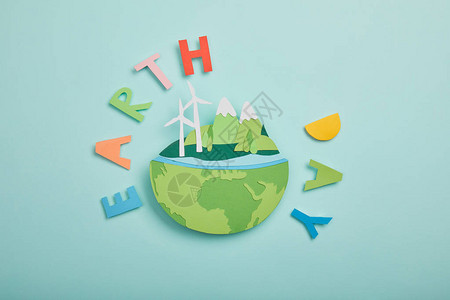 国际能源署具有可再生能源和绿松石背景的彩色纸质字母地球日概念的剪纸背景