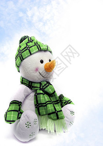 有绿色围巾和帽子的雪人带雪图片