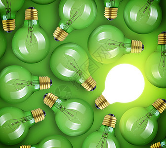 大创意的概念绿色背景上的发光灯泡图片