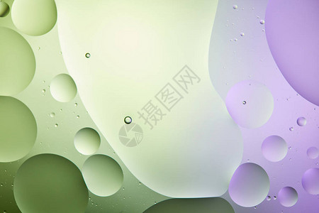 淡绿色和紫色混合水和油的抽象背景以背景图片