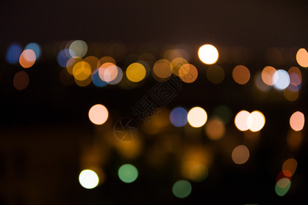 明亮的夜晚城市灯光在远处模糊图片