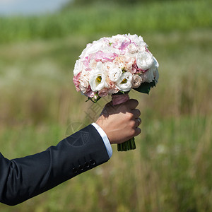 美丽的新娘在婚礼前拿着花束图片