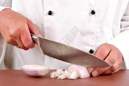 女厨师用菜刀切了一个洋葱图片