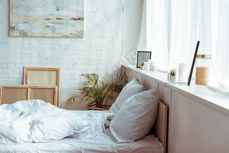 现代卧室有舒适的床枕头毯子图片
