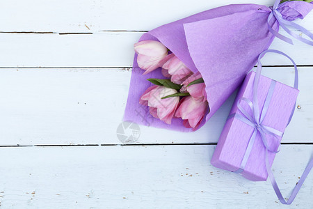 紫罗兰纸上粉红色郁金香花的美丽花束和浅图片