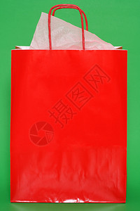 绿色背景上的红色购物袋图片