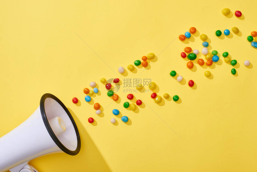 黄色背景上带多彩糖果的扩图片
