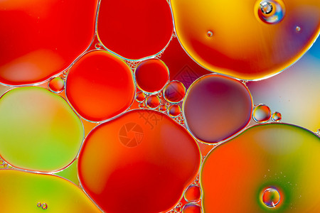 彩色背景下水中的油滴图片