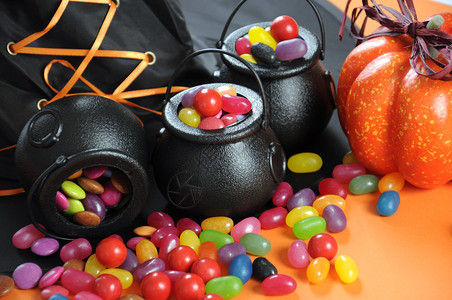 万圣节快乐的糖果在戏法或治疗中随身带着魔帽和橙色背图片