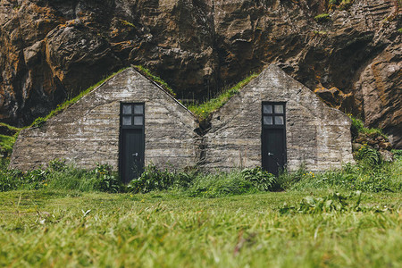 冰岛山下有青草屋顶的美丽居住房图片