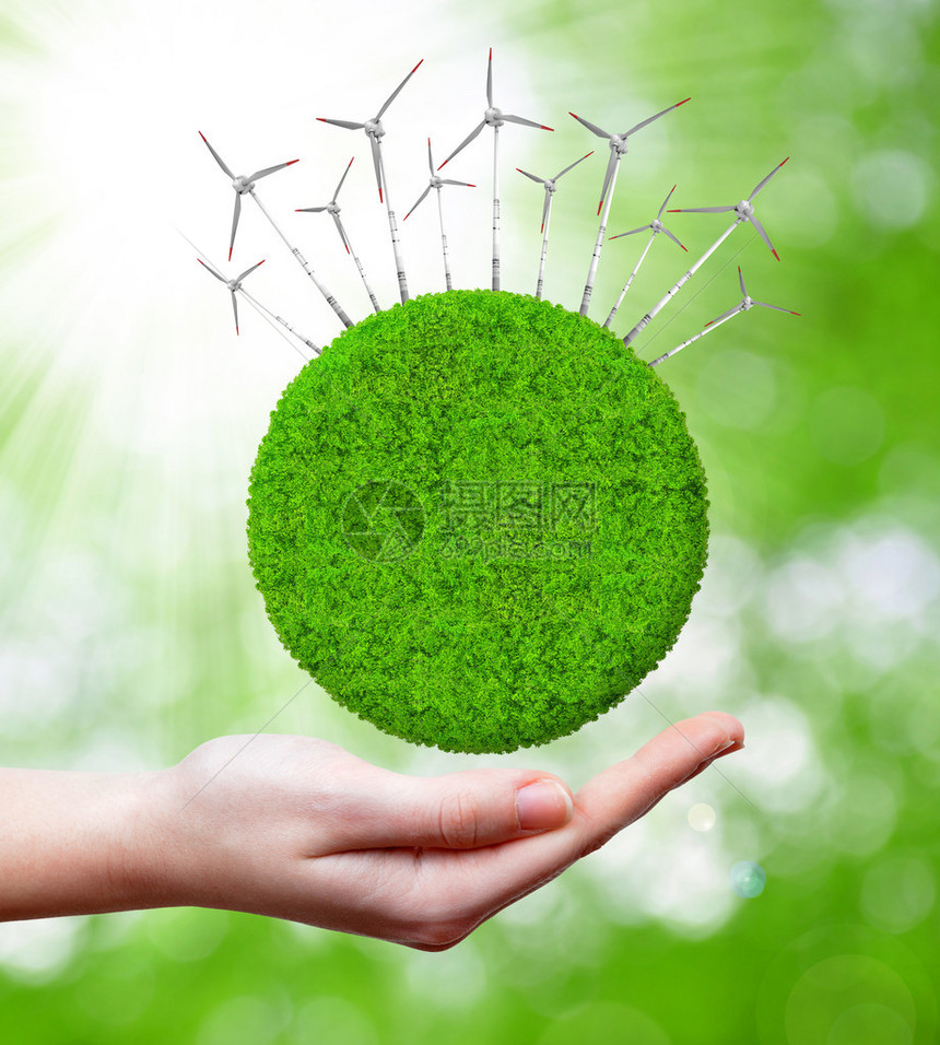 带风力涡轮机的绿色星球绿色能源概念图片