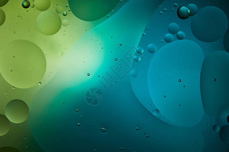 蓝色和绿色混合水和油的美丽抽象背景图片