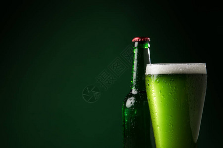玻璃瓶和一杯绿色啤酒图片