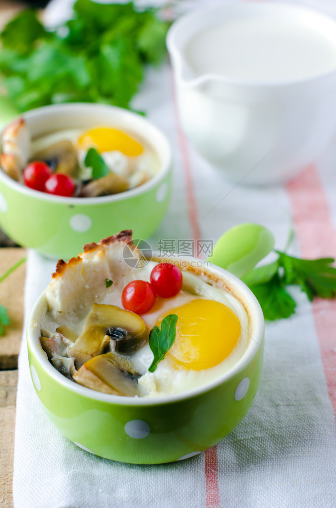 鸡蛋和蘑菇一起烤在绿色盘子里图片