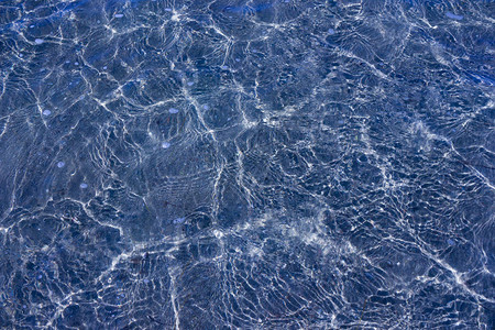 阳光下透明的海浪的纹理图片