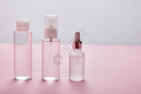 粉色和灰色背景的一套化妆瓶图片
