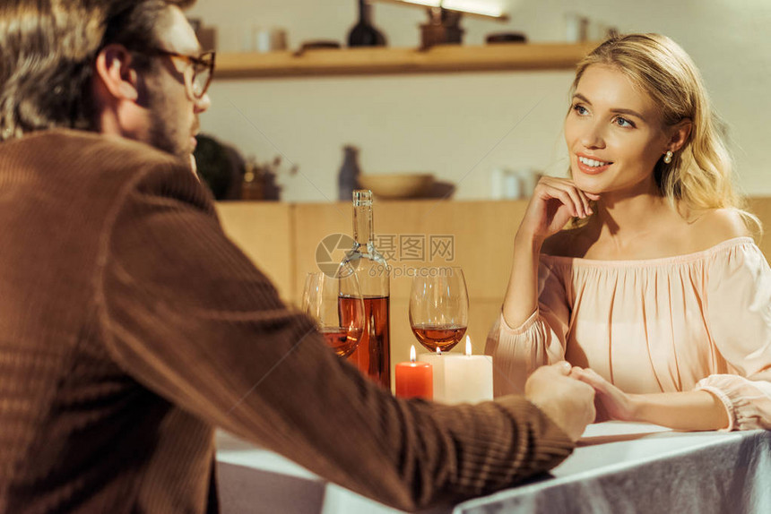 在咖啡馆约会时男人与漂亮女友握图片