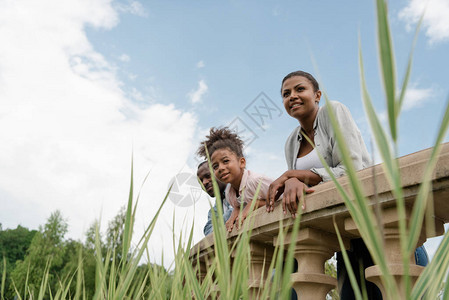 African小女孩和父母一起站图片