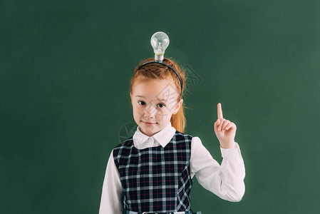 可爱的红发小女学生头顶有灯泡用手指着图片
