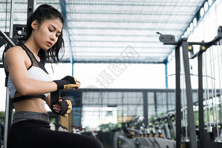 健身中心戴手套的年轻女子女运动员准备在健身房训练运动型女孩准备在健图片