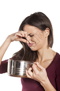 恶心的女人拿着一锅有食物的锅子图片