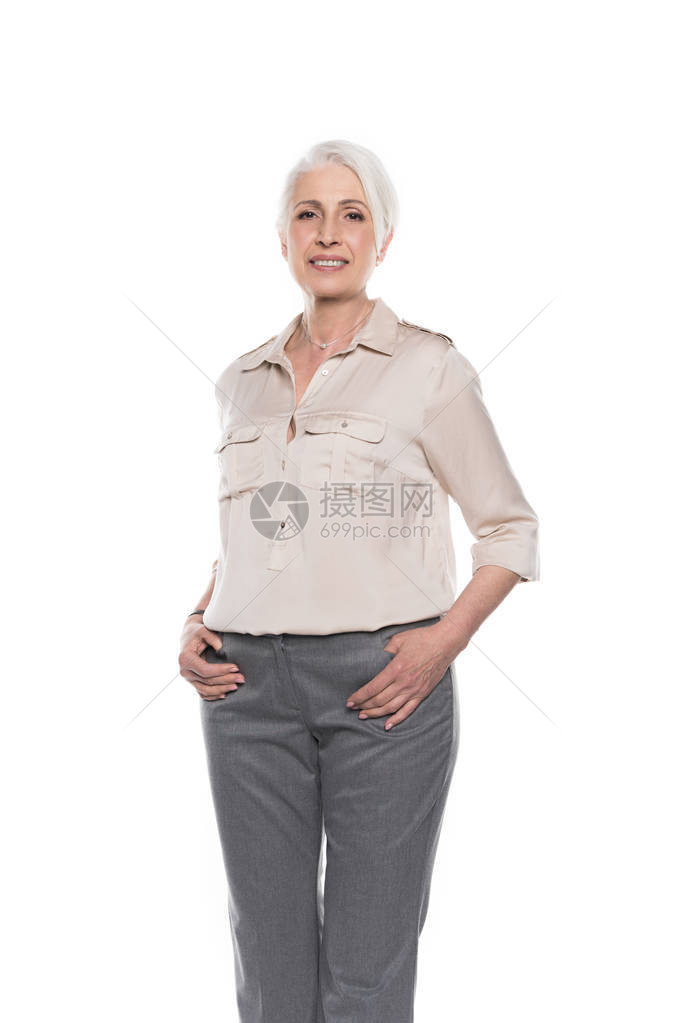美丽的高夫人拿着手站在口袋里看着在白色上被图片