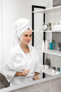 系浴袍腰带照镜子的女人图片