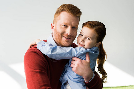 快乐的红发父亲和女儿拥抱在镜头下图片