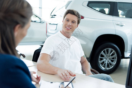 销售经理和客户签署关于购买汽车图片