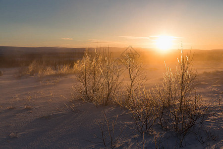 大雪覆盖冰雪的冰地景观日落时有裸露图片