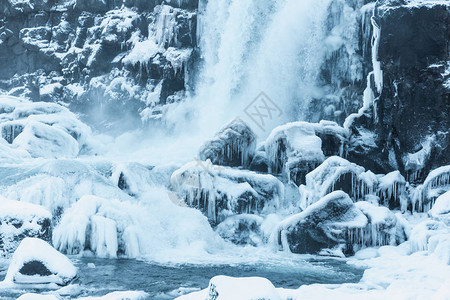 风景美丽的瀑布冰冻的河流和冰雪覆盖的岩石图片