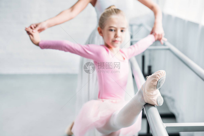 在芭蕾舞演播室用粉红色塔图与儿童一起参加成人芭蕾图片