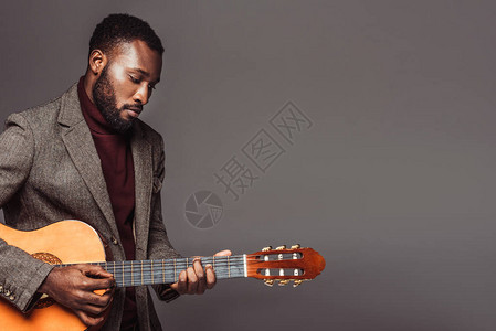 AfricanReforward美国古老风格的吉他手弹着音响吉他在图片