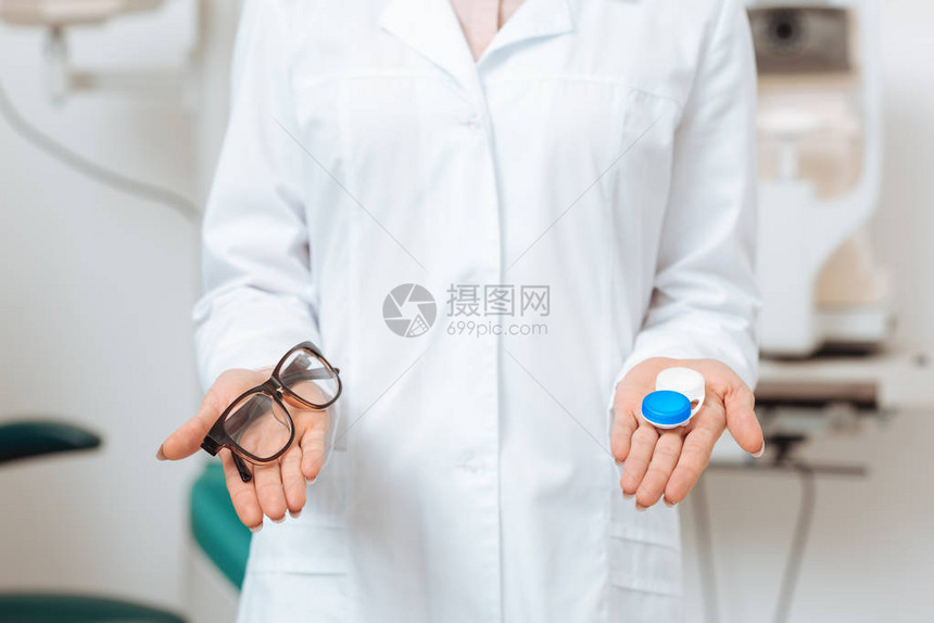 白色大衣中的观察家用眼镜和在诊所的隐形眼镜图片