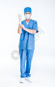 戴面罩的成熟男外科医生戴上白色隔图片