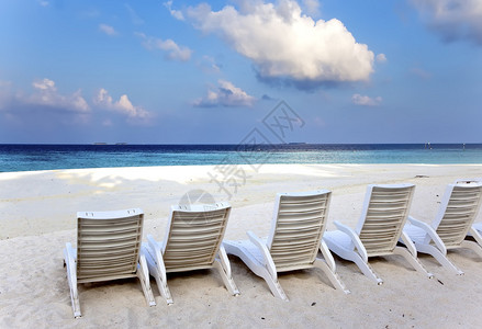 日出时海前的一些空沙滩椅图片
