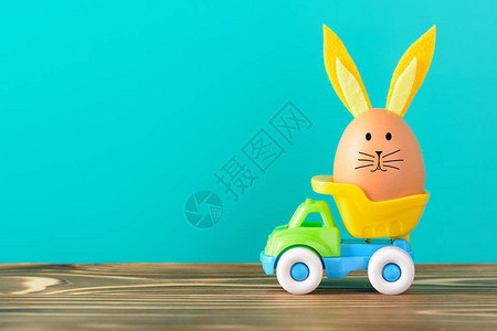 鸡蛋与装饰兔子耳朵和玩具卡车鼻子背景图片