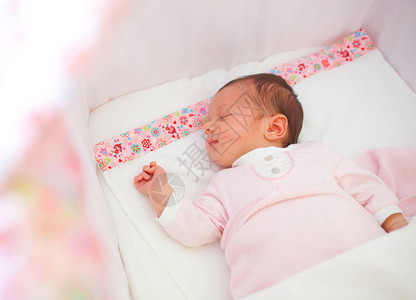 在摇篮中熟睡的新生女婴的肖像图片