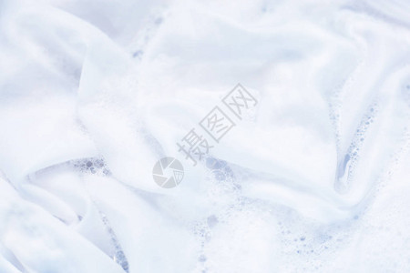 白衣服浸泡在水中与洗涤粉末图片