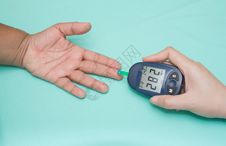 糖尿病患者用血糖仪测量葡萄糖图片