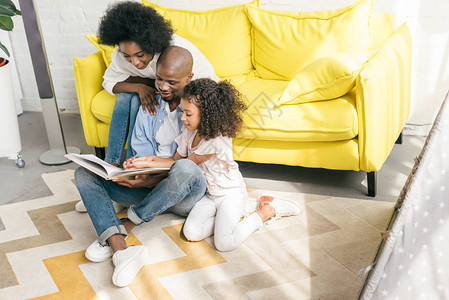 非裔美国人家庭在家里一起阅图片