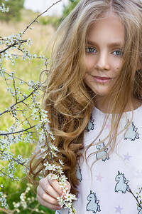 夏季童装详情页金发长的可爱小女孩站在花环的草地上背景