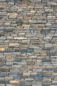 从苗条的花岗岩砖的古老墙壁背景图片