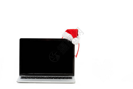 在笔记本电脑上戴圣诞帽白色背景背景图片