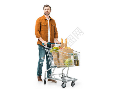 快乐的男子携带购物小车和用纸袋中产品在白色上孤立的白图片