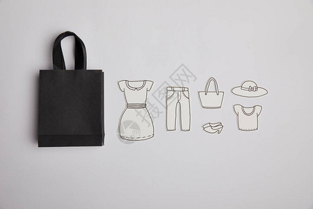 黑购物袋和灰色背景纸衣购物概图片